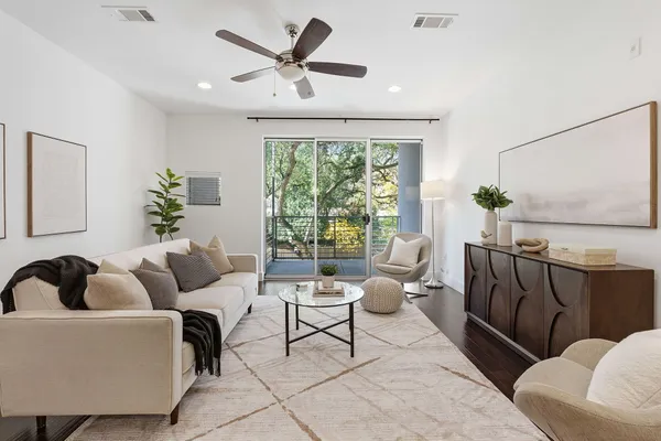 a living room with furniture and wooden floor