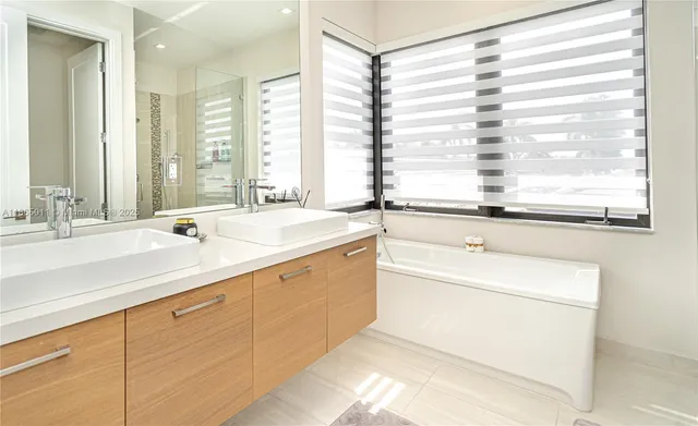 a kitchen with a sink a refrigerator and cabinets