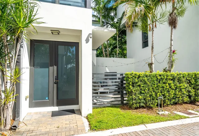 a living room with fireplace furniture and a large window