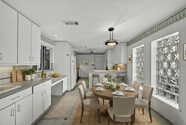 a view of a dining room with furniture and window