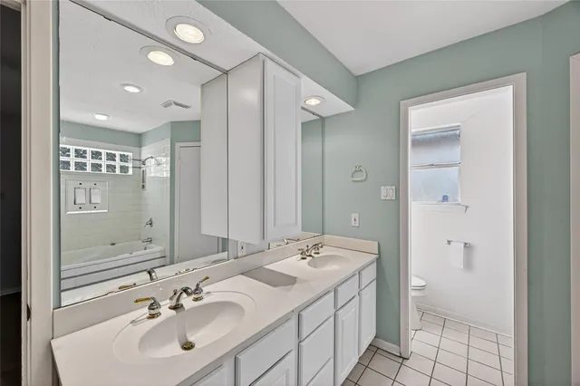 a bathroom with a sink shower and a mirror
