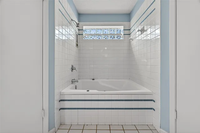 a bathroom with a bathtub and shower