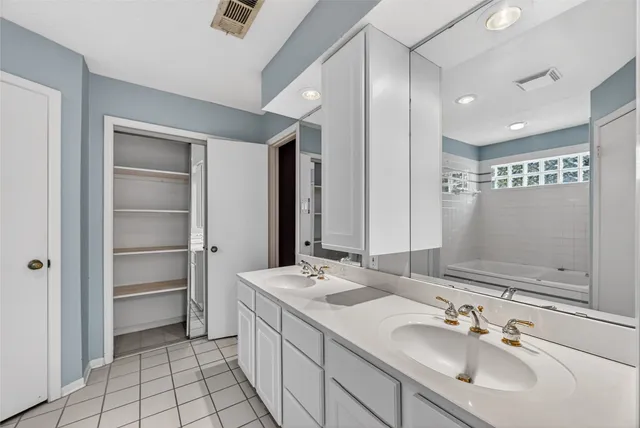 a bathroom with a sink double vanity and a mirror