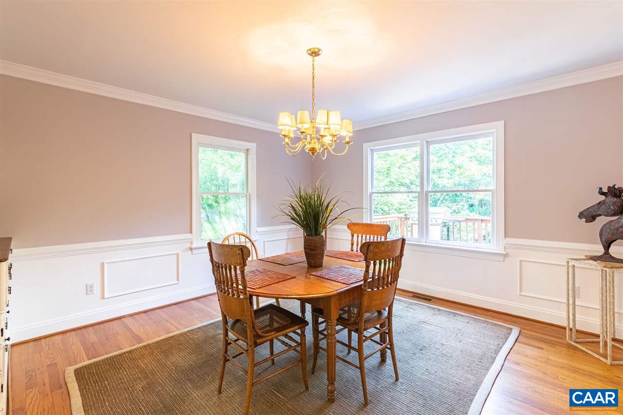 329 Starcrest Road Charlottesville, VA 22902 - Photo 17 of 45 a dining room with furniture a rug a potted plant and a chandelier