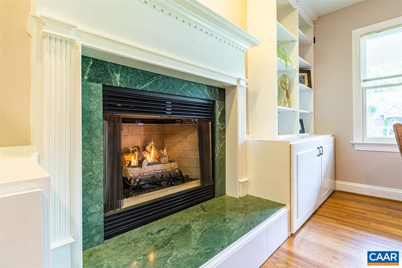 329 Starcrest Road Charlottesville, VA 22902 - Photo 6 of 45 a view of a hallway with wooden floor and a fireplace
