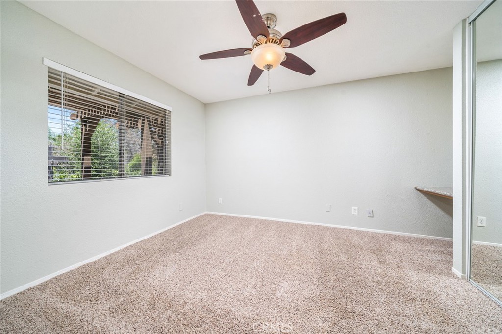 16639 Fox Glen Road Riverside, CA 92504 - Photo 79 of 153 an empty room with a window and a ceiling fan