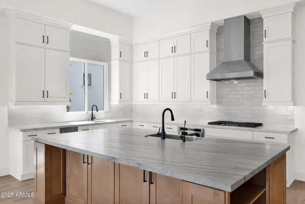 a kitchen with a sink a stove and cabinets