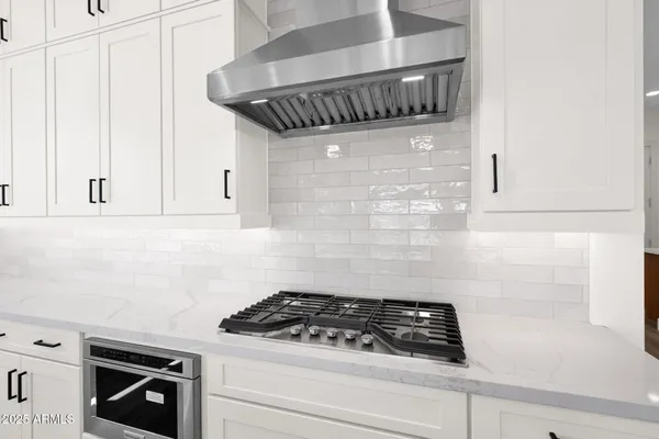 a kitchen with cabinets and stainless steel appliances