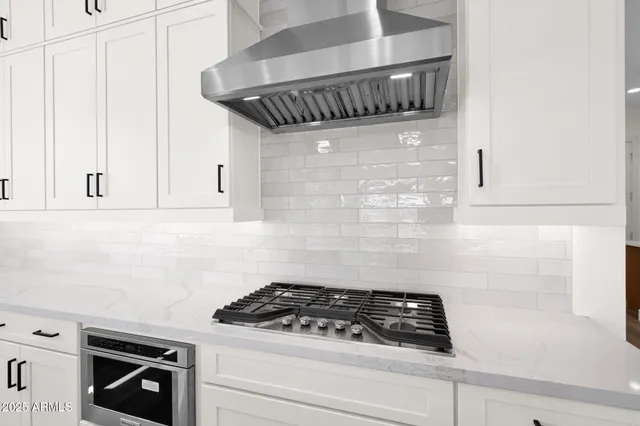 a kitchen with cabinets and stainless steel appliances
