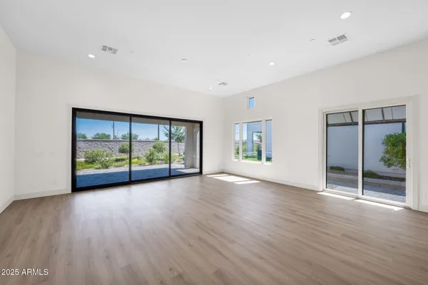 a large kitchen with cabinets wooden floor and stainless steel appliances