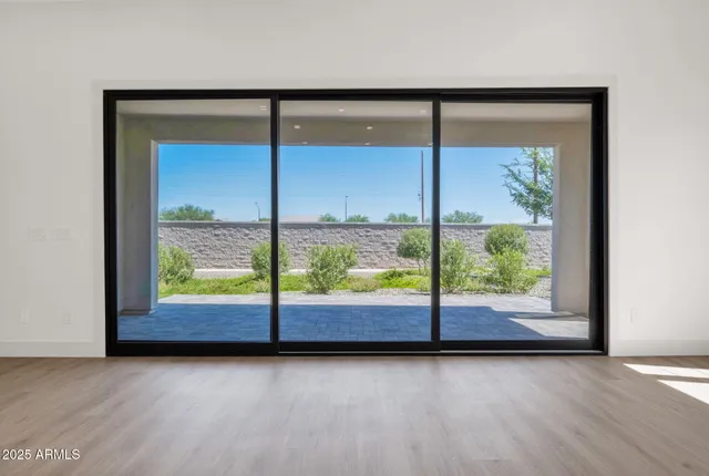 a large white kitchen with a large window a sink and stainless steel appliances
