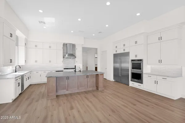 a bedroom with bed and a large window