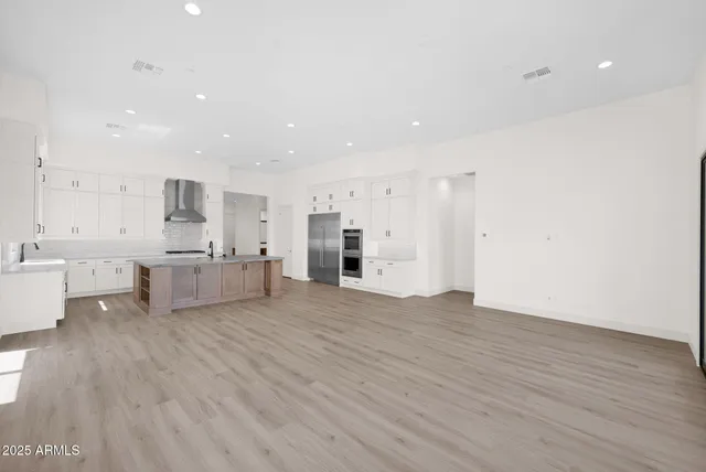 a bathroom with a double vanity sink mirror and bathtub