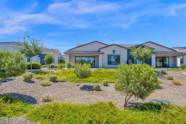 an aerial view of residential houses with outdoor space and swimming pool