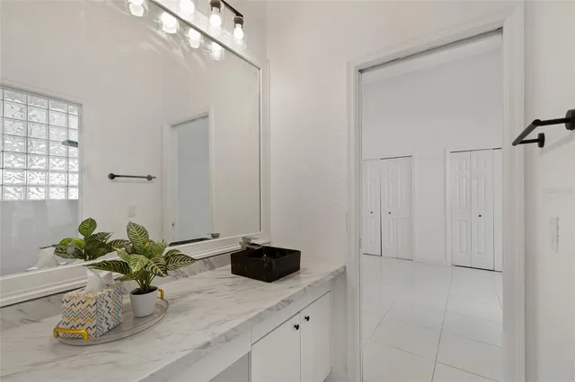 a bathroom with a granite countertop sink a toilet and bathtub