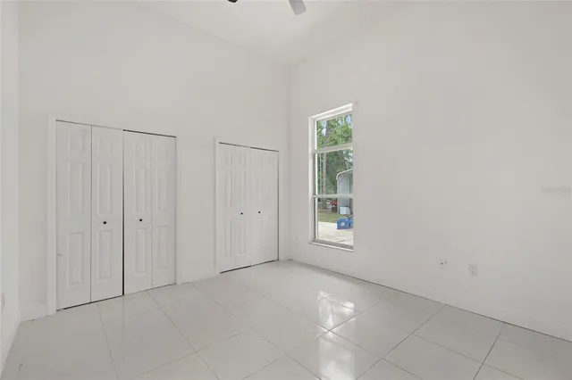 a bathroom with a granite countertop sink a large mirror and a bathtub with shower