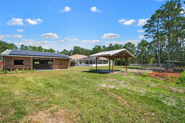 a view of a hallway with wooden floor and a living room