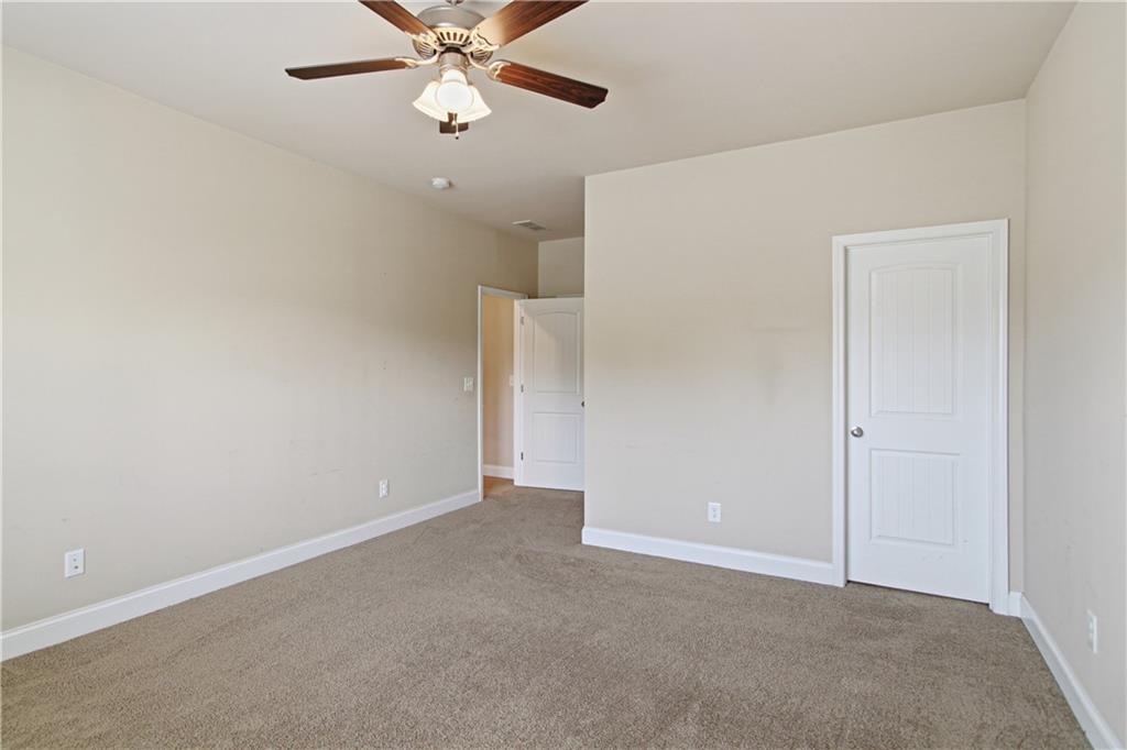 114 Madison Street Canton, GA 30115 - Photo 23 of 39 an empty room with closet and a chandelier fan