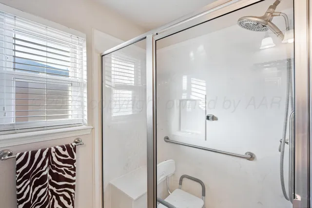 a bathroom with a shower and a mirror