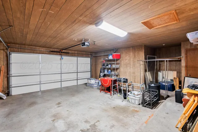 a view of a garage room with furniture and a window