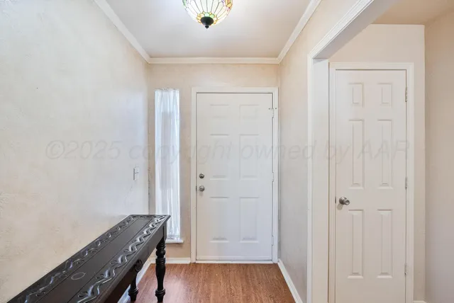 a view of a hallway with wooden floor and closet