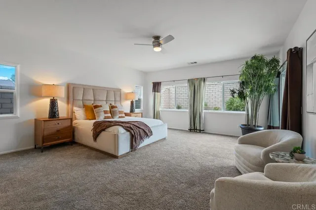 a spacious bedroom with a bed and a couch