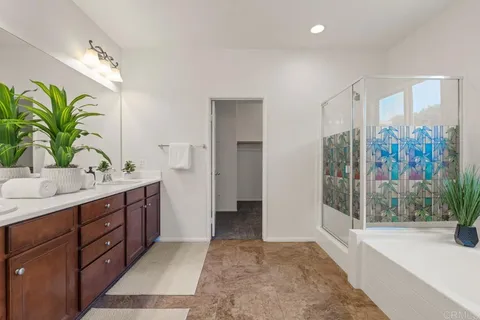 a bathroom with a tub sink and mirror