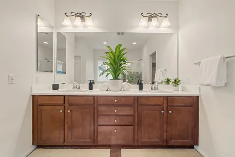 a bathroom with a double vanity sink and a mirror