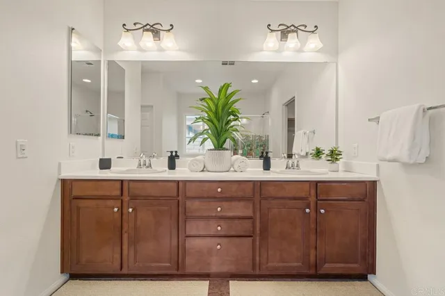 a bathroom with a double vanity sink and a mirror