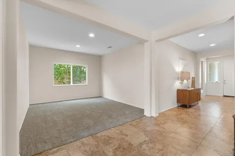 a bathroom with a granite countertop sink a toilet and a mirror
