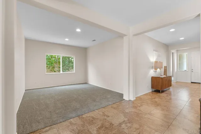 a bathroom with a granite countertop sink a toilet and a mirror