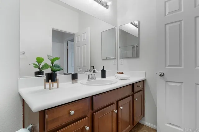 a bedroom with a bed and a potted plant