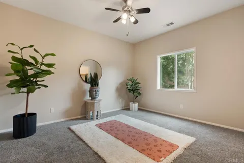 a spacious bedroom with a bed a couch and cabinet
