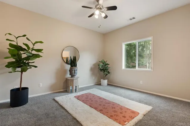a spacious bedroom with a bed a couch and cabinet