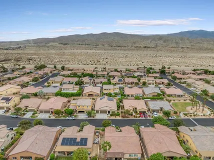 an aerial view of residential building with green space