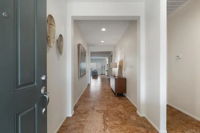 a view of a hallway with living room and furniture
