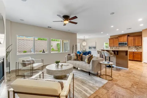 a living room with furniture and kitchen view