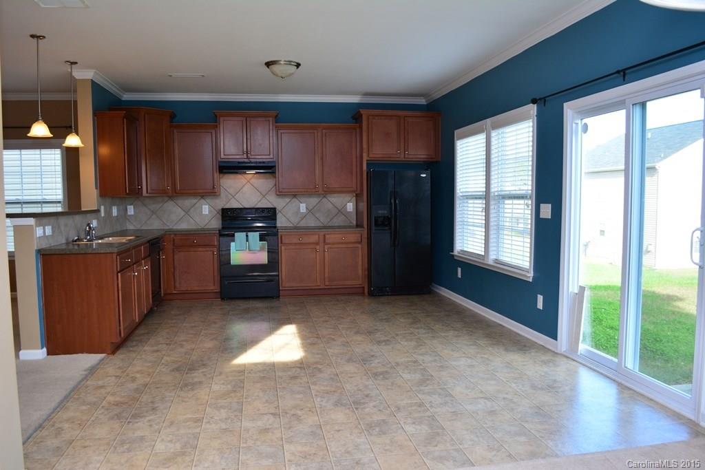 657 Shellbark Drive Concord, NC 28025 - Photo 24 of 24 a kitchen with stainless steel appliances granite countertop a stove sink and cabinets