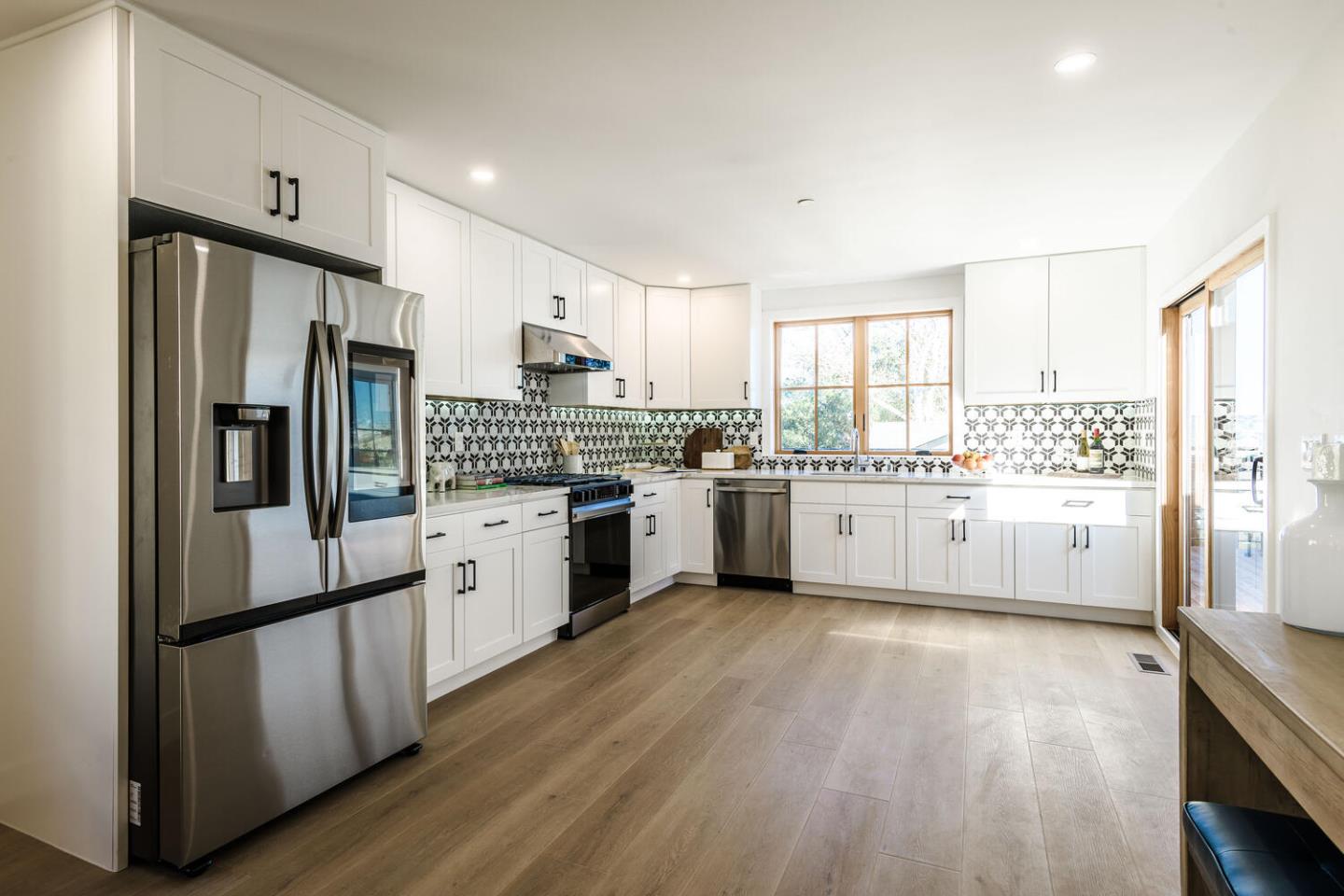 611 Bayview Avenue Millbrae, CA 94030 - Photo 9 of 34 a kitchen with stainless steel appliances a refrigerator sink and cabinets