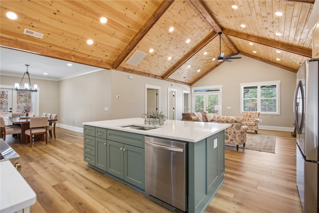 147 McAlister Road West Union, SC 29696 - Photo 49 of 49 This inviting home features an open floor plan with a kitchen island and high vaulted ceilings.