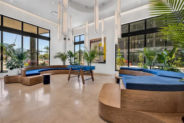a living room filled with furniture and a potted plant
