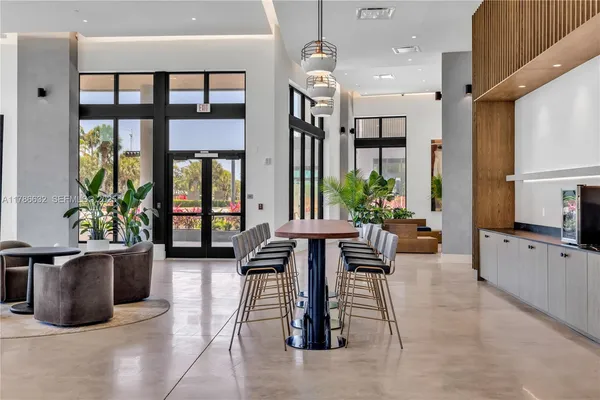 a living room with furniture potted plant and windows