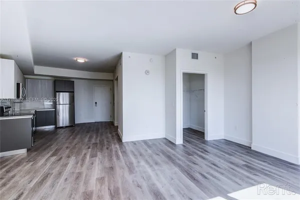a view of kitchen with wooden floor and electronic appliances