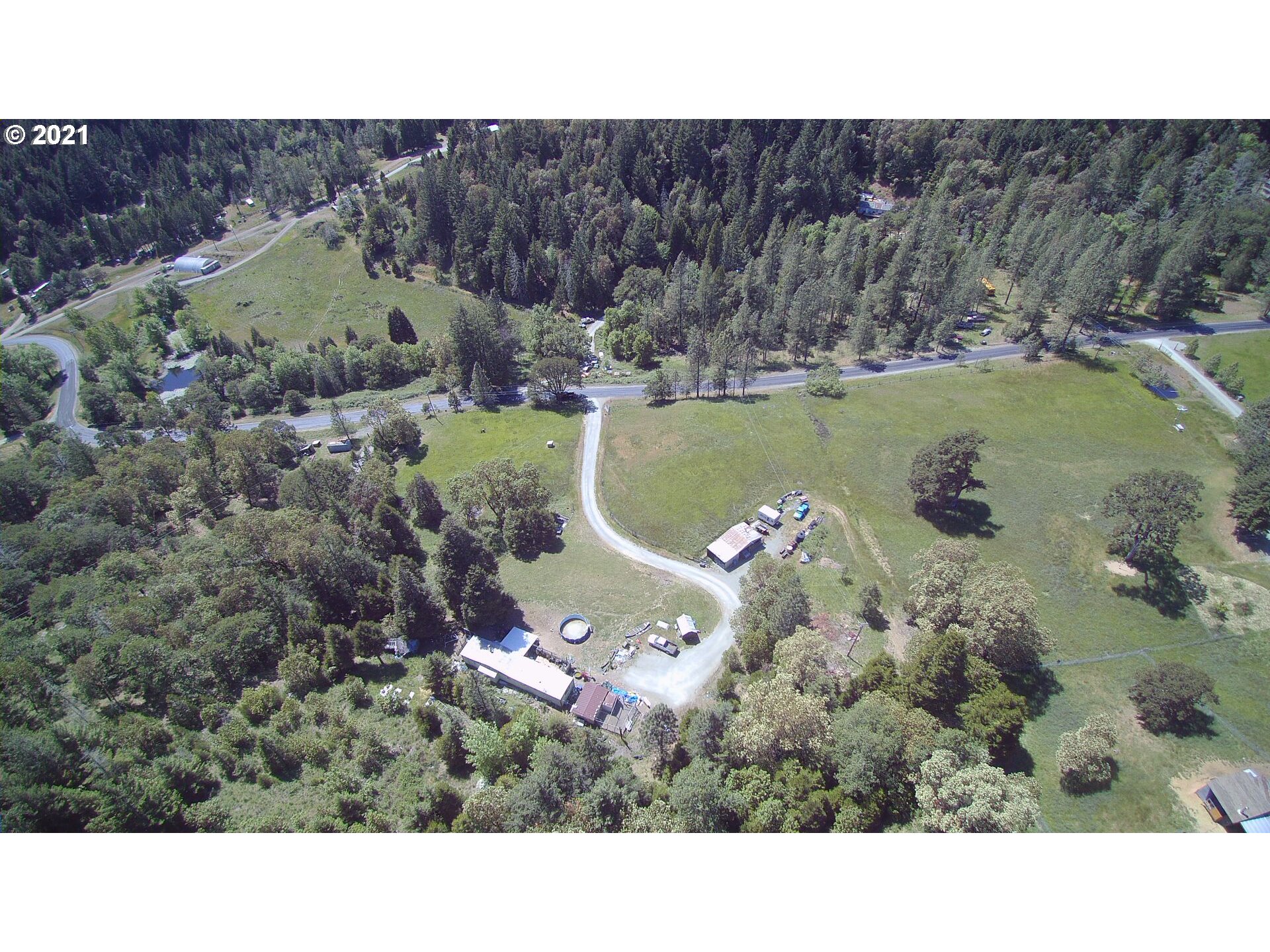 1827 Spring Brook Road Myrtle Creek, OR 97457 - Photo 10 of 15 a view of a house with a yard and a car park