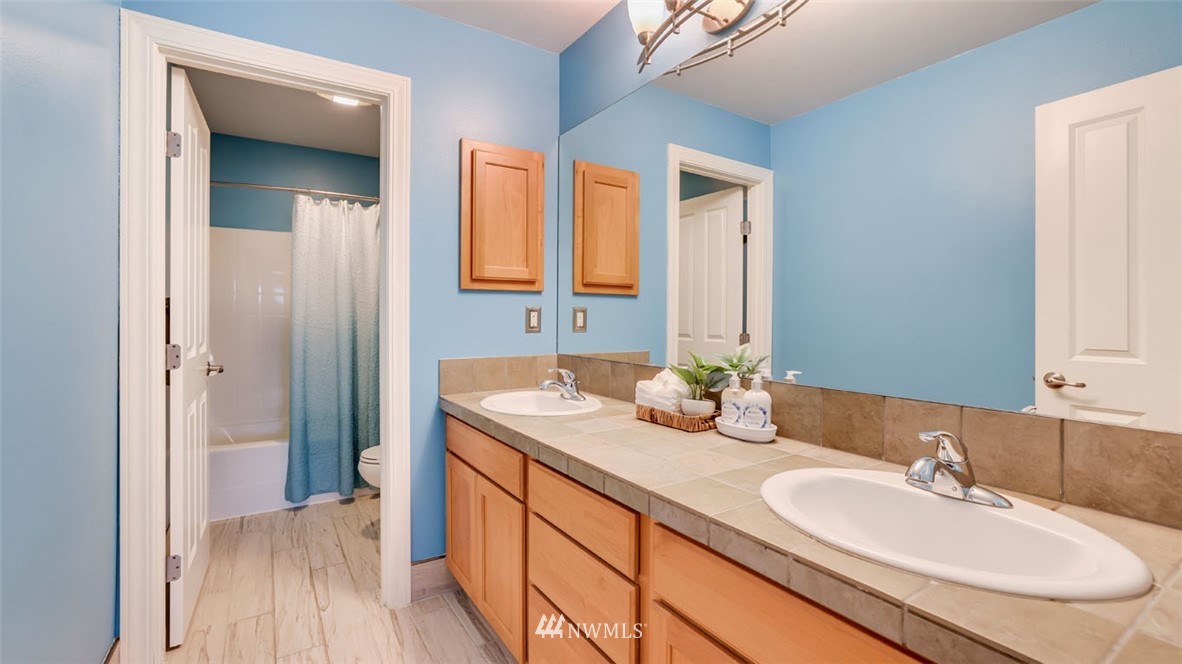 16013 Southeast 137th Terrace Renton, WA 98059 - Photo 34 of 40 a bathroom with a granite countertop sink and a mirror