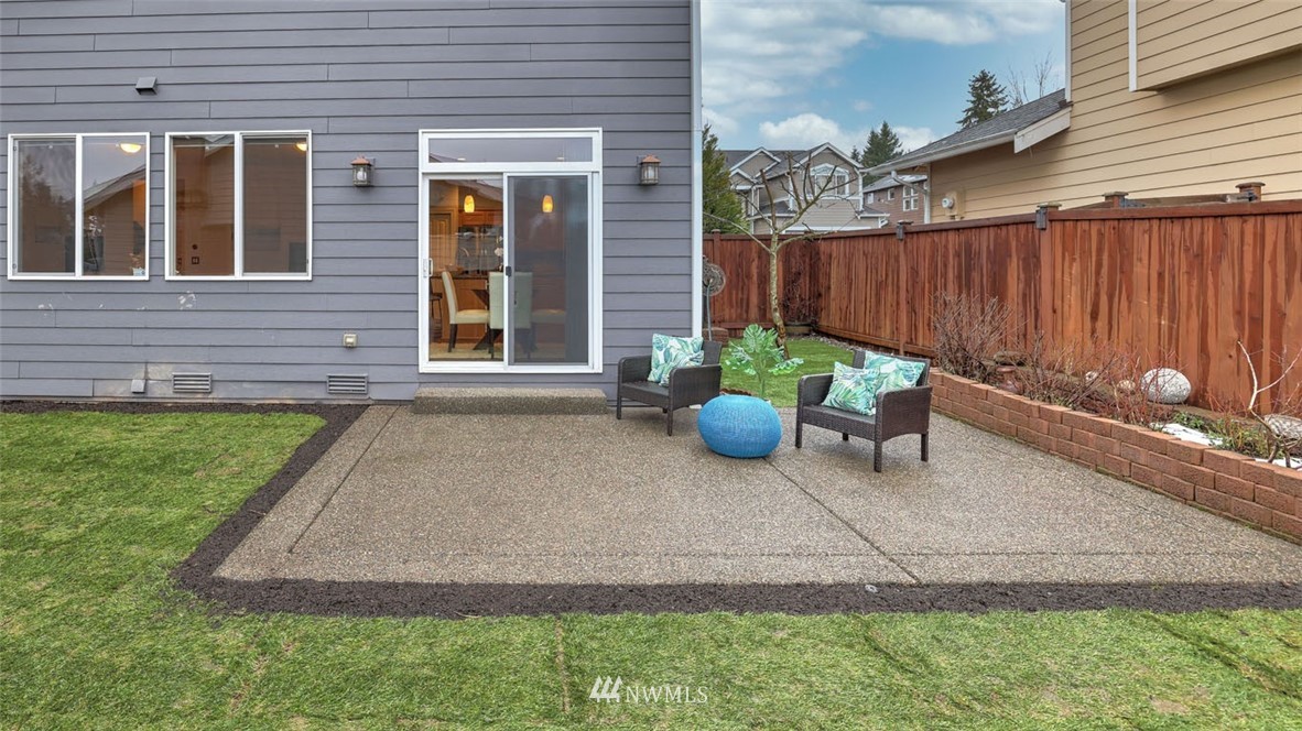 16013 Southeast 137th Terrace Renton, WA 98059 - Photo 40 of 40 a backyard of a house with chairs and a yard