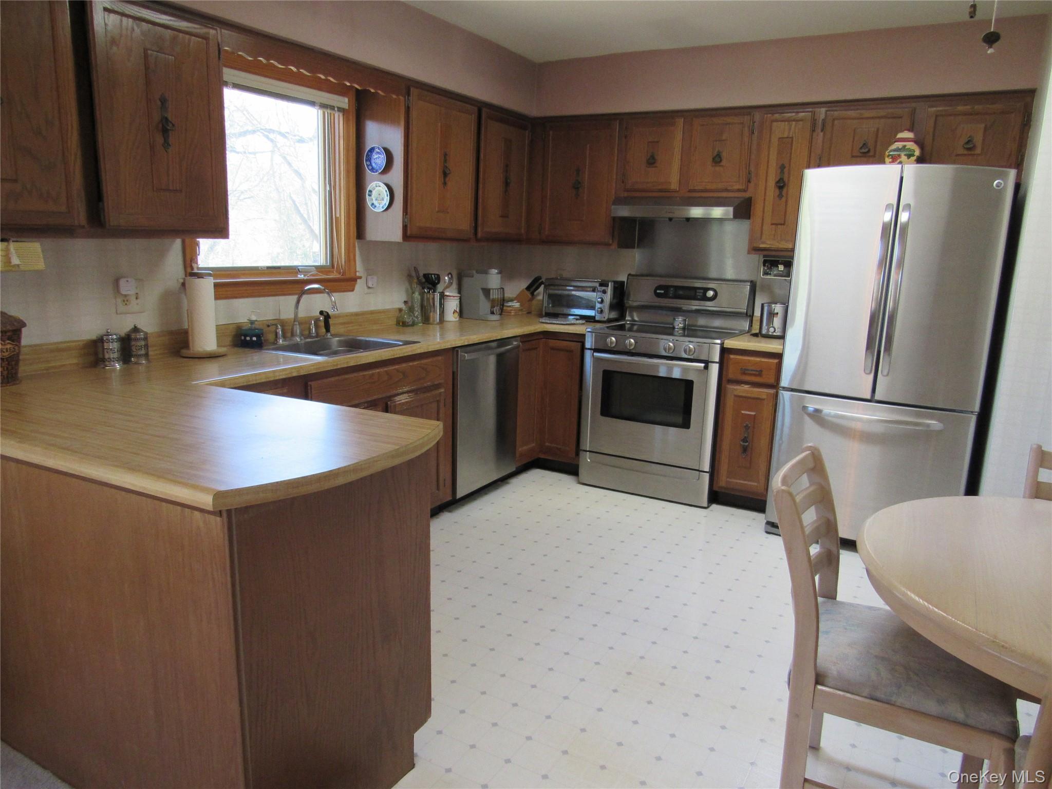 5 Hillside Road Slate Hill, NY 10973 - Photo 10 of 22 The kitchen features wood cabinetry, light-toned countertops, and stainless steel appliances including a refrigerator, range, and dishwasher
