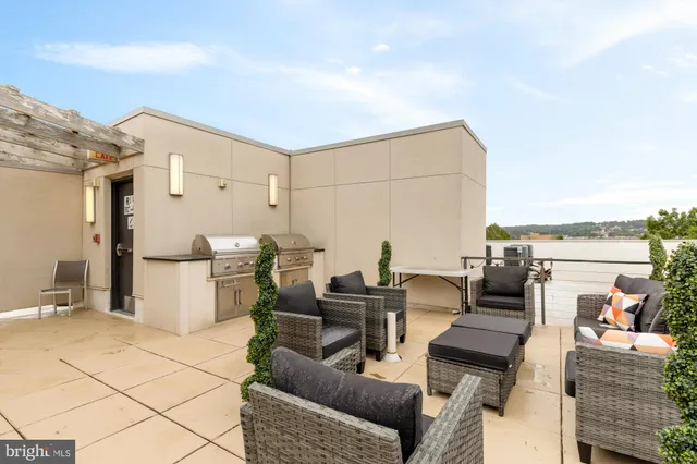 a balcony with chairs and white walls