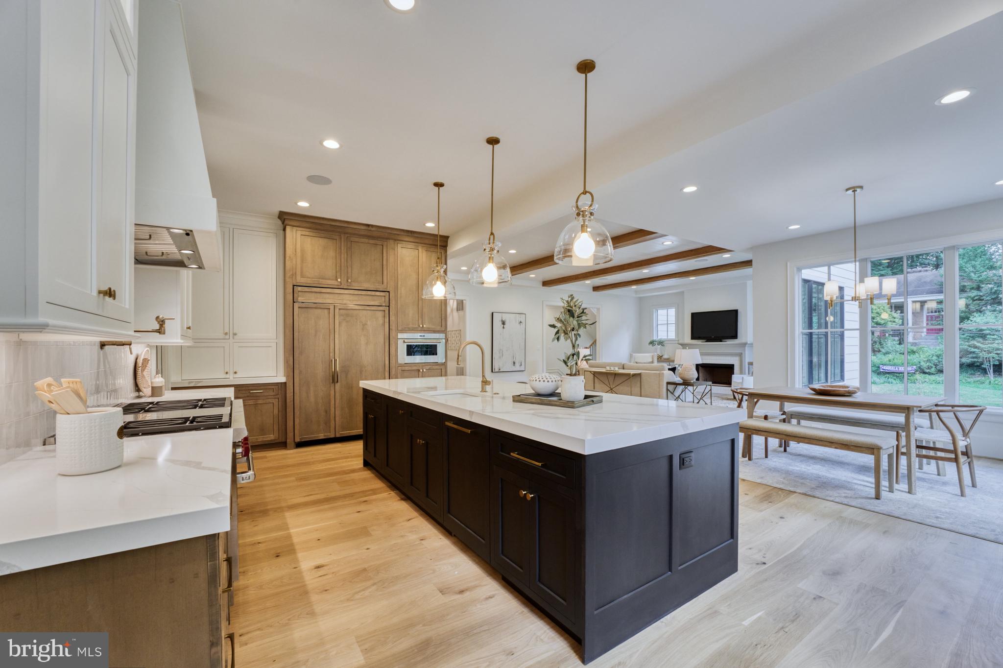 1440 Ironwood Drive McLean, VA 22101 - Photo 17 of 64 a large kitchen with kitchen island a sink a stove a dining table and chairs