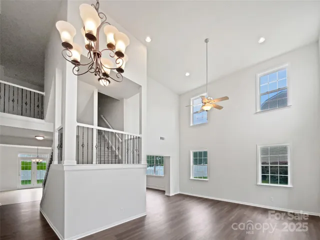 a view of a livingroom with furniture wooden floor and windows